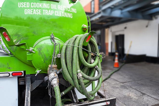 grease trap pumping truck servicing a restaurant in Garfield